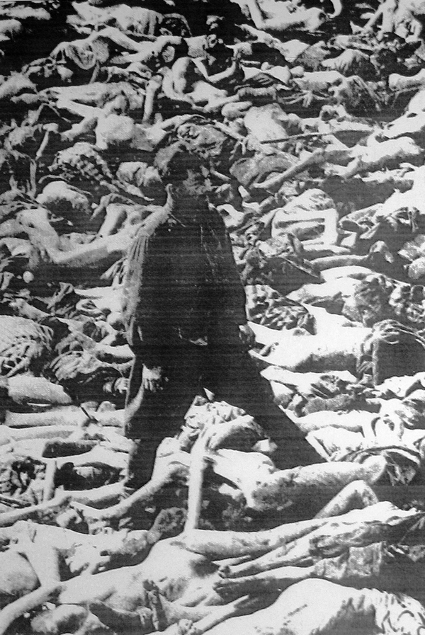 Dr Fritz Klein is standing in a mass grave