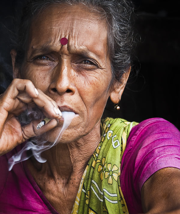 woman smoking beedi.took this in a flower market near howrah