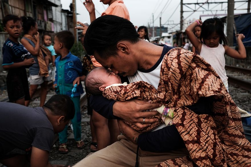 Jonathan Holding His One-Month-Old Daughter After Coming Back From His Work