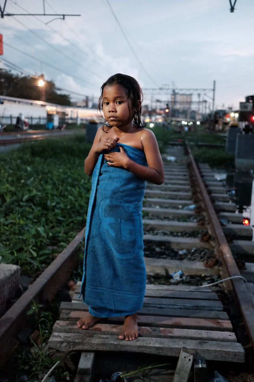 Young Girl Drying Herself After Shower. There Are Very Few Facilities In The Slum, People Bath With Water That Comes From A Small Well Next To The Tracks