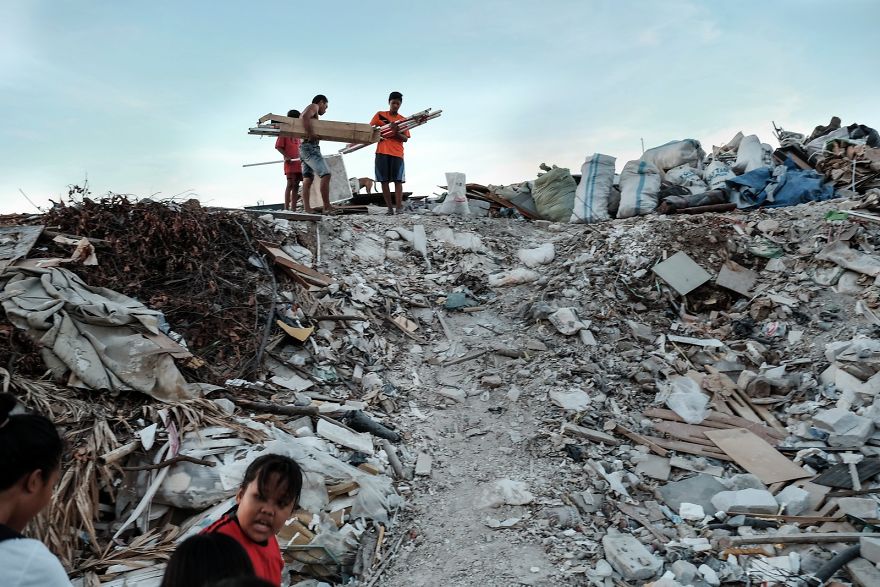 People Collecting All Kind Of Goods From The Garbage Damp Next To The Slum Area