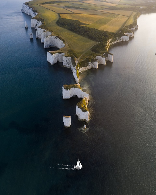 Boat cruising past Old Harry Rocks, Dorset