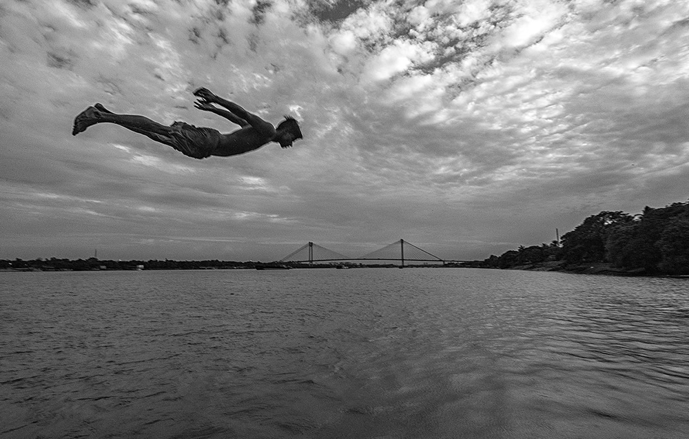 Flying Boy in Howrah with 2nd Hoogly bridge in backdrop over River Ganges